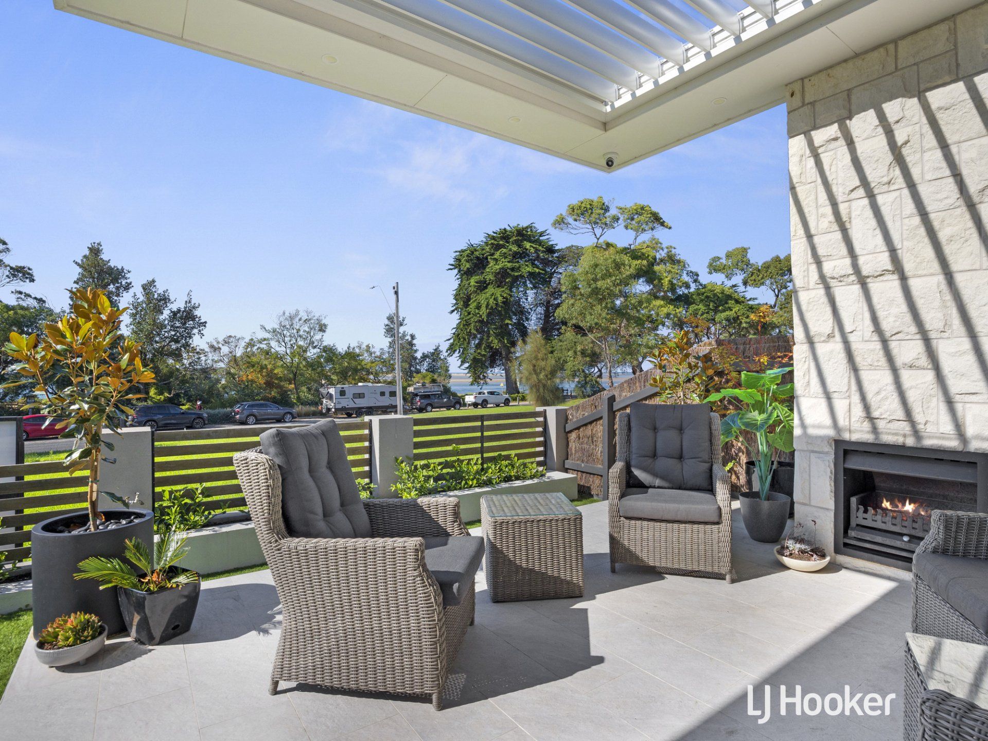 A patio with chairs and a fireplace with hooker written in the corner