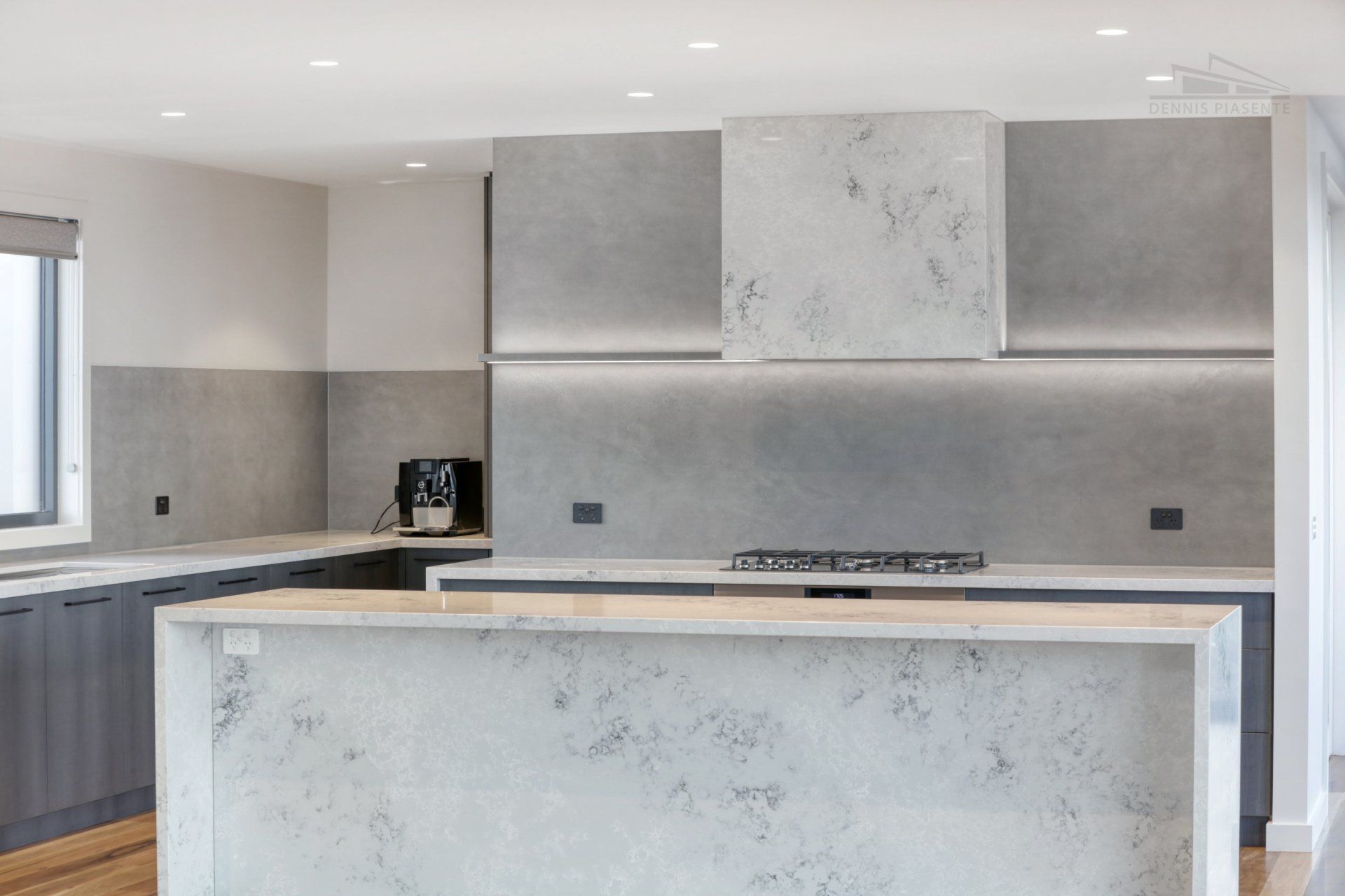 A kitchen with a large island and a stove top oven.