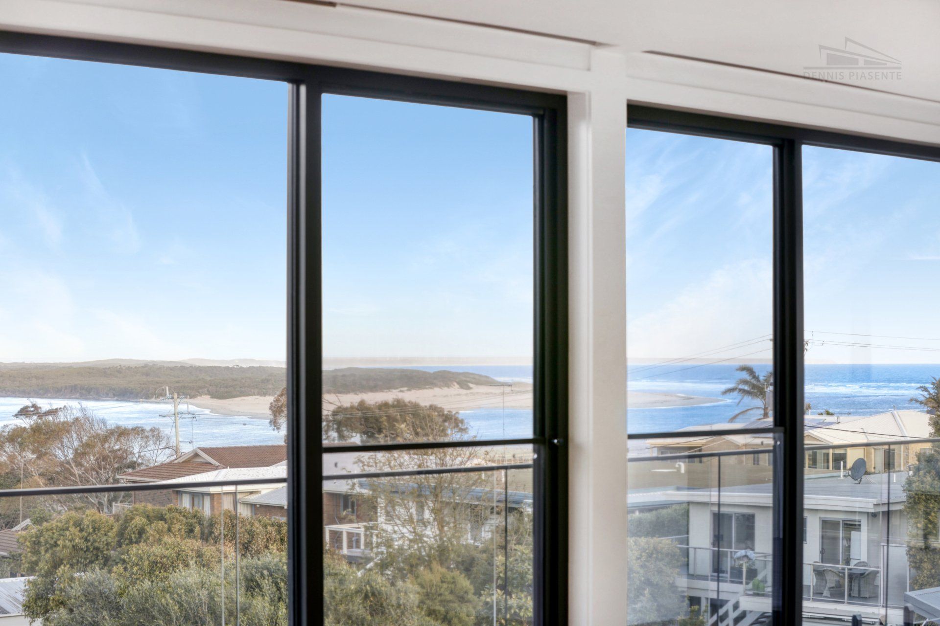 A large window with a view of the ocean.