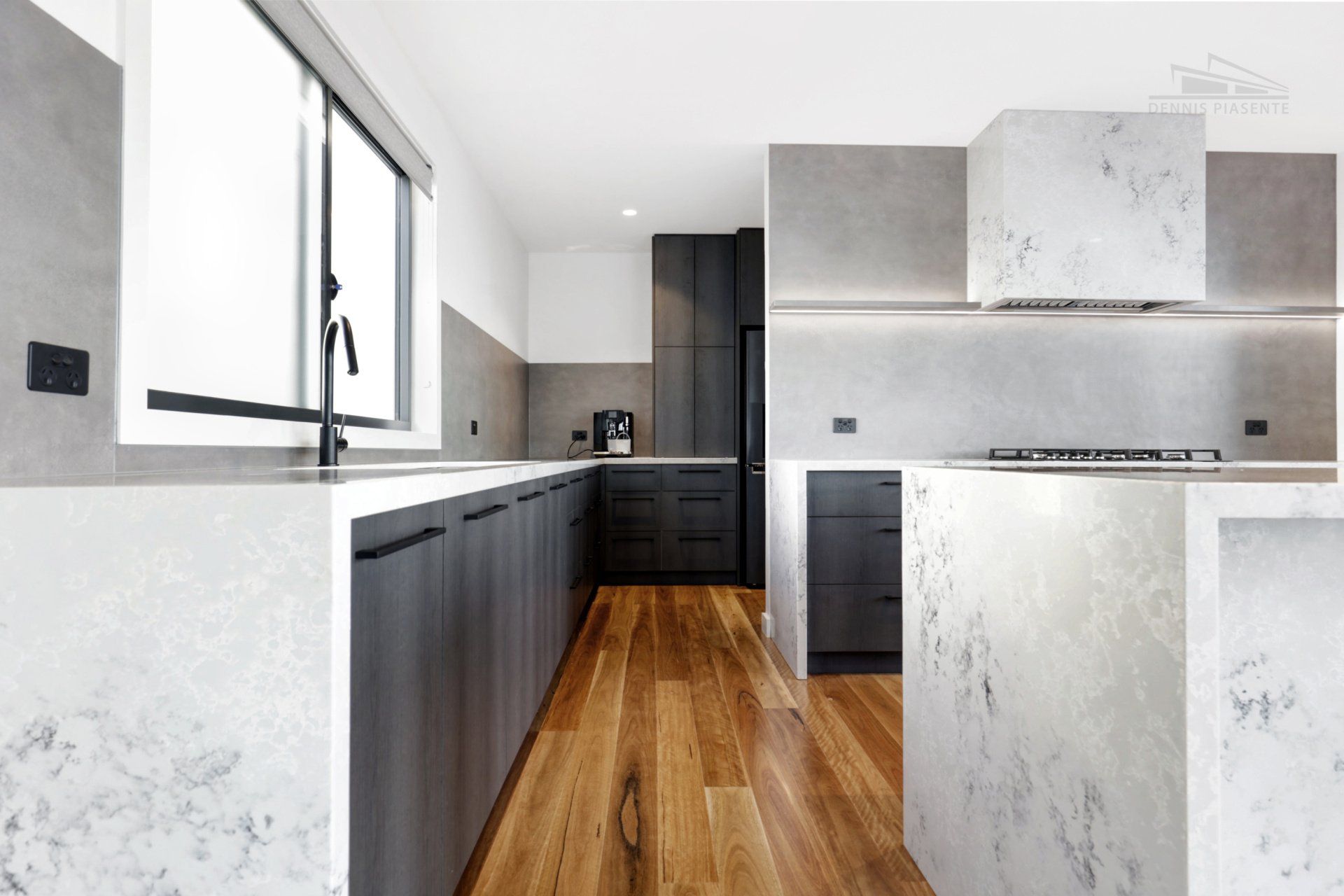 A kitchen with black cabinets and white counter tops