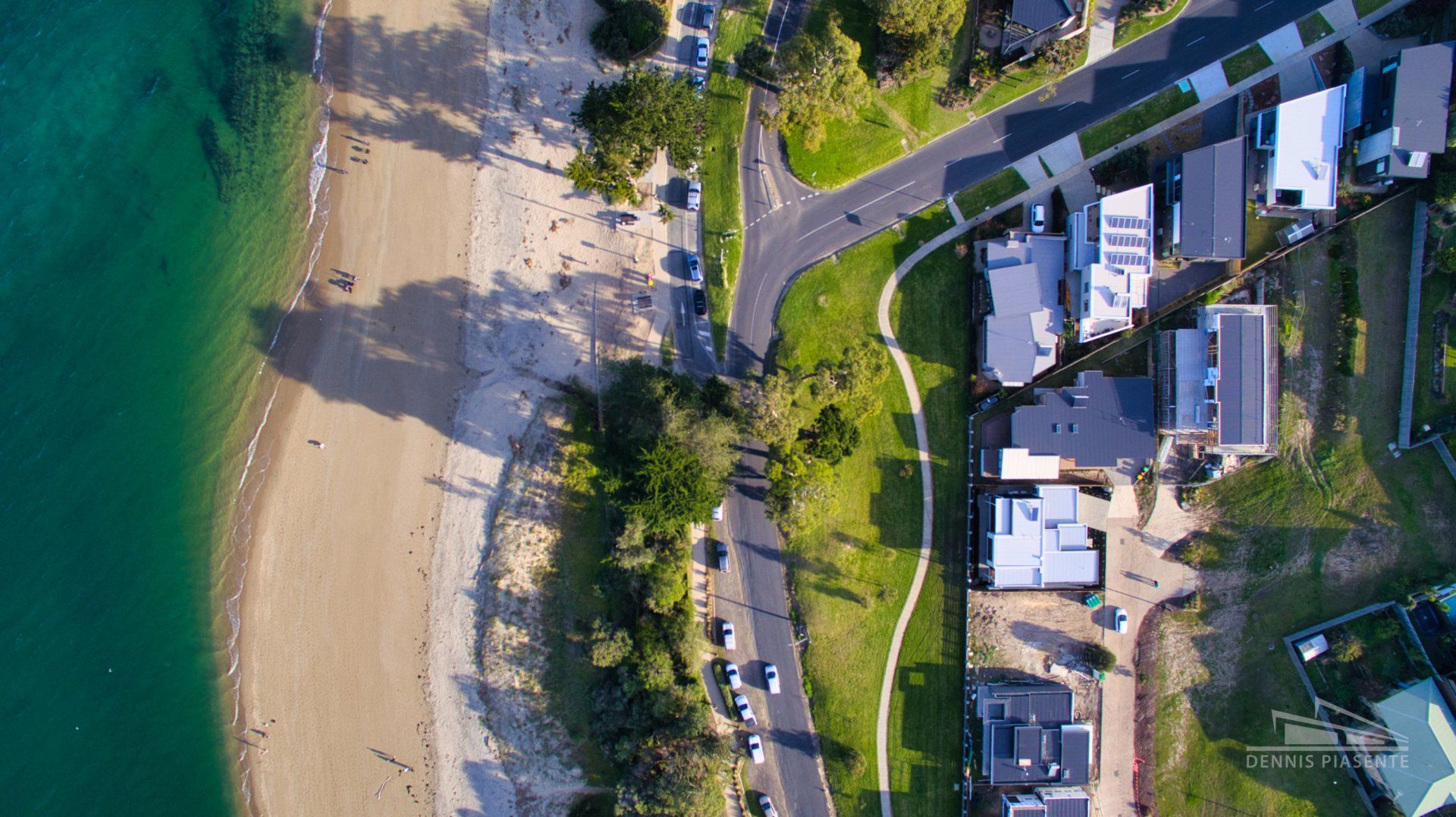 An aerial view of a beach and a residential area.