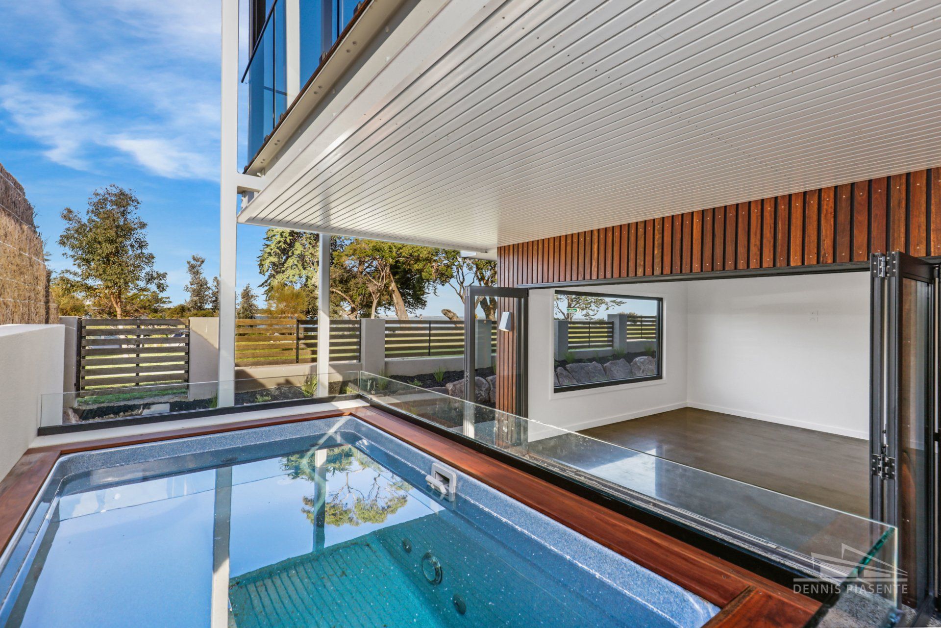 There is a large swimming pool in the middle of a house.