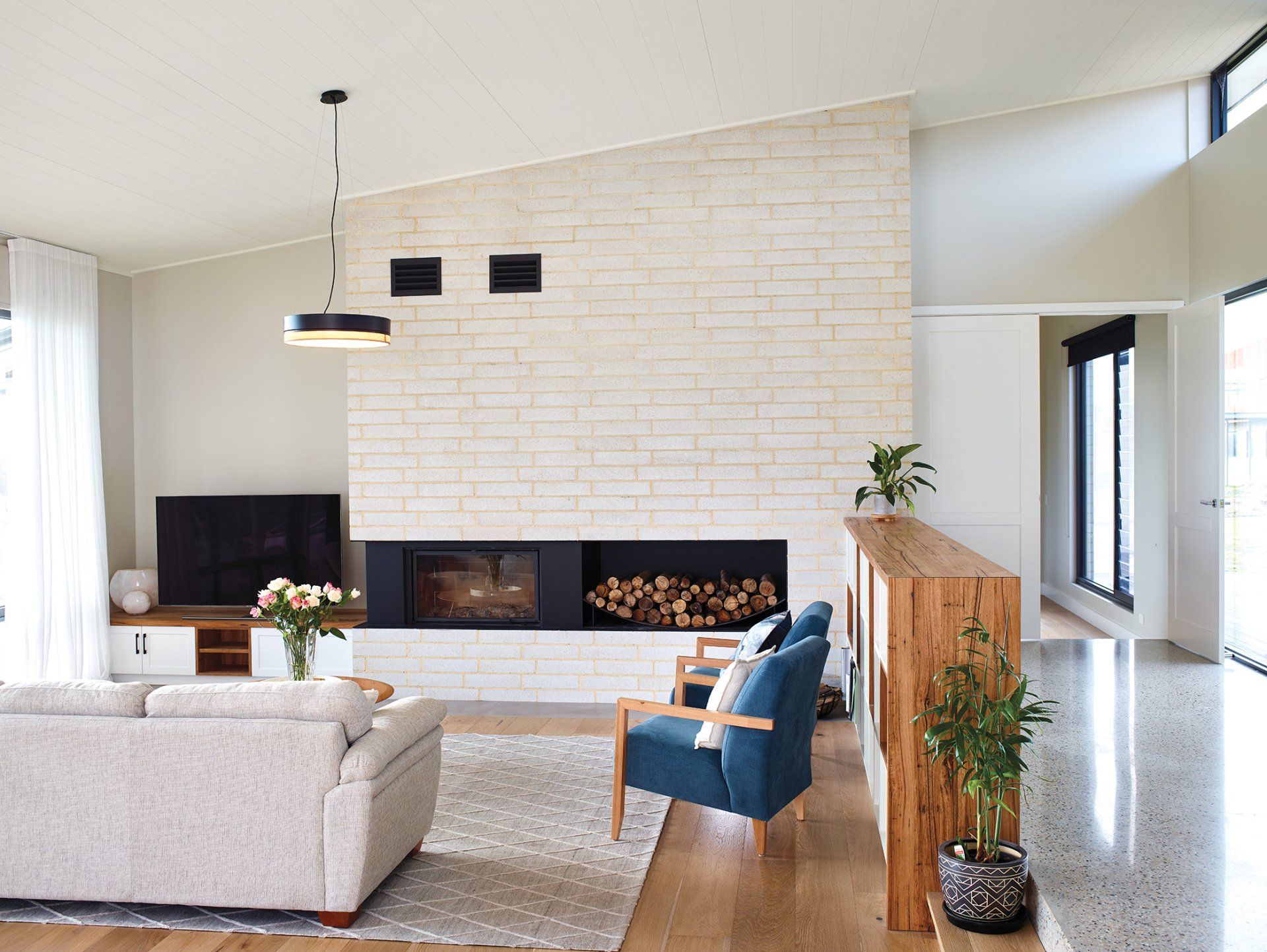 There is a fireplace in the middle of the living room.