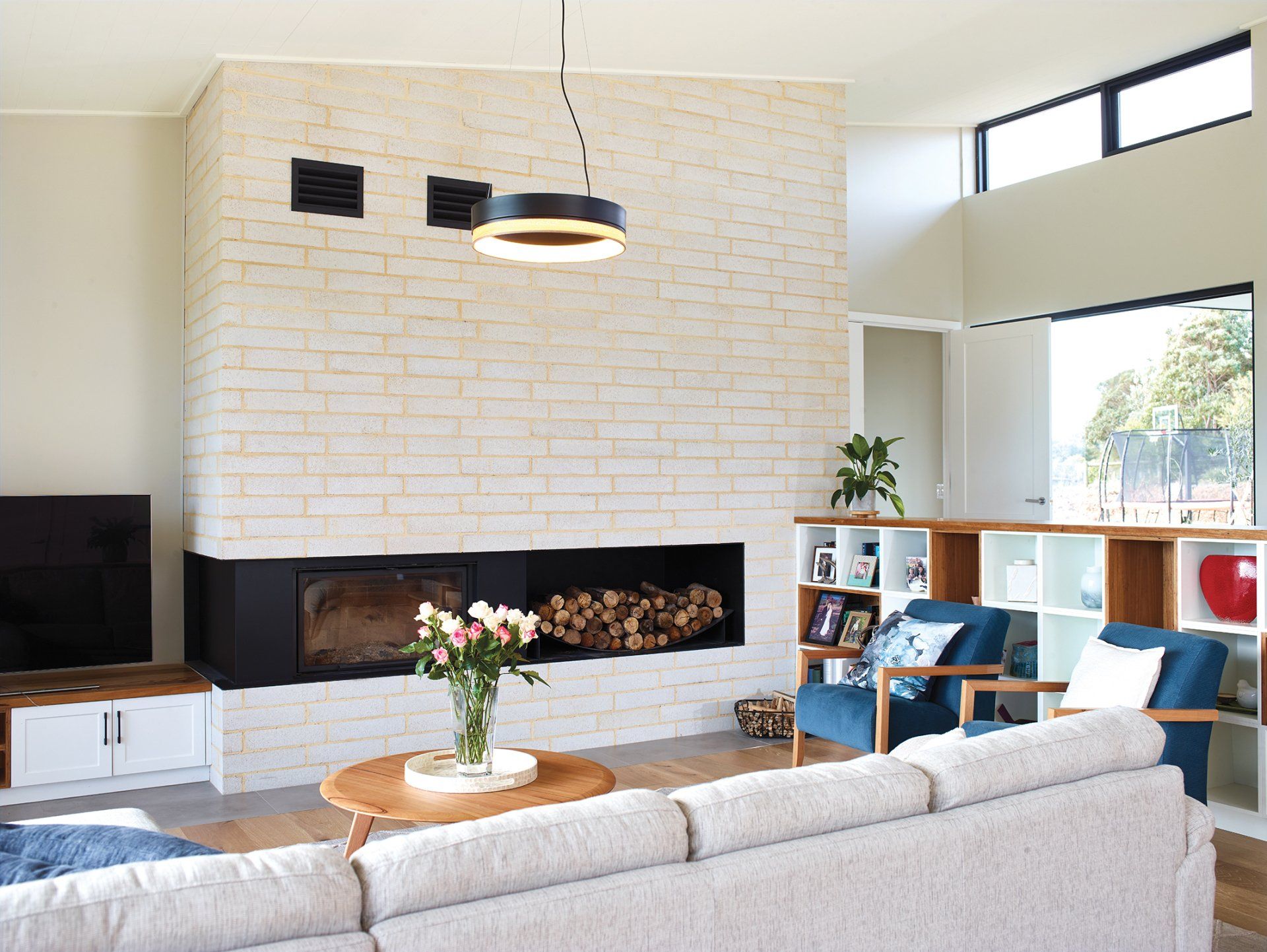 A living room with a couch , chairs , and a fireplace.
