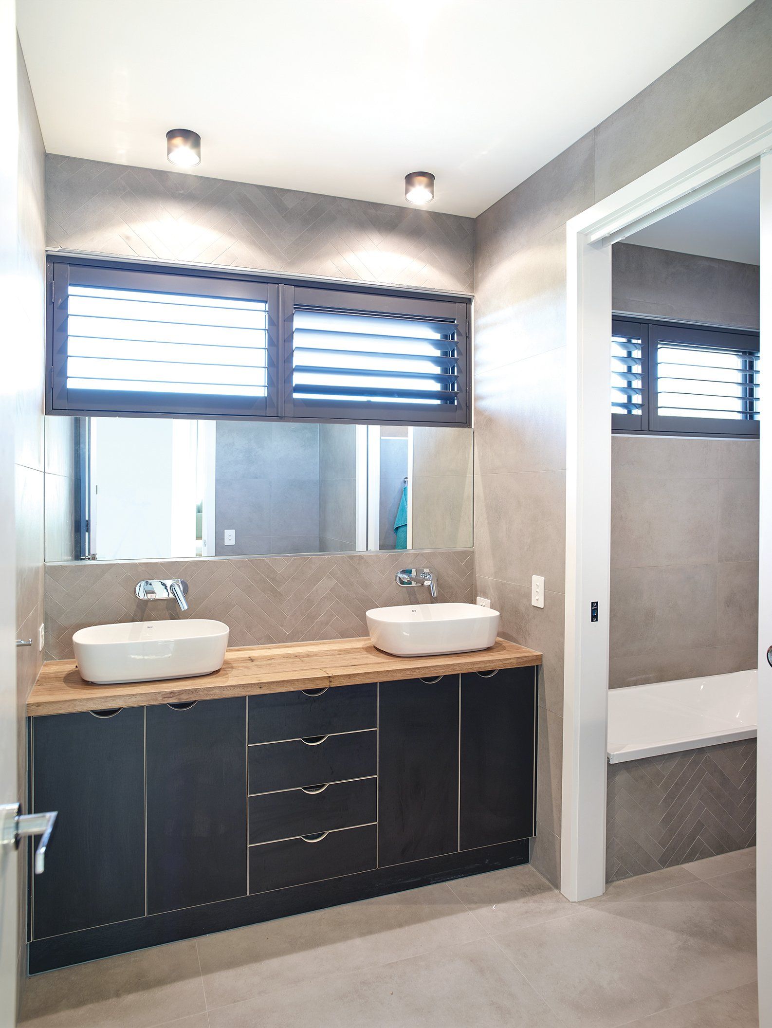 A bathroom with two sinks and a large mirror