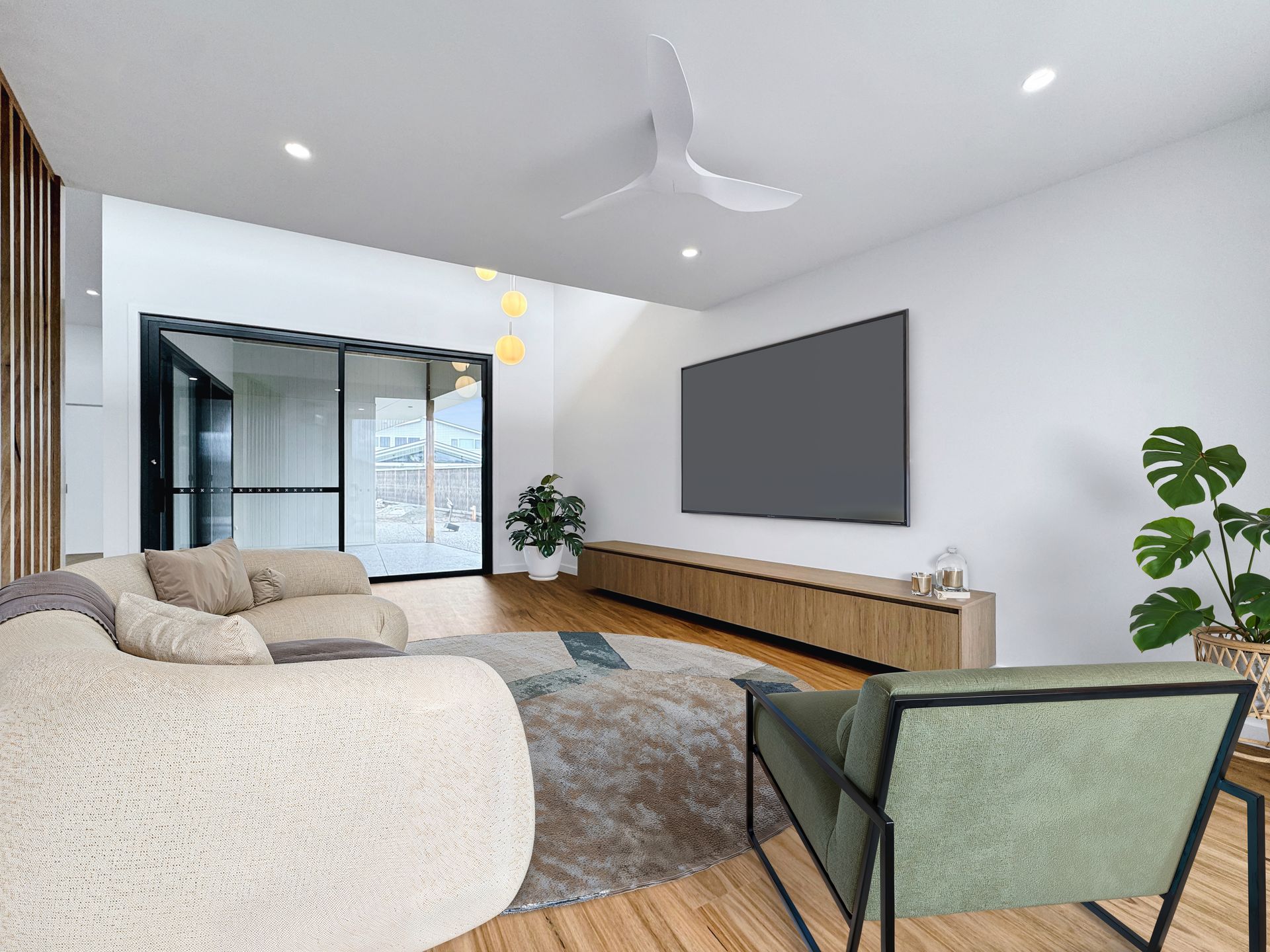 A living room with a couch , chairs , and a flat screen tv.