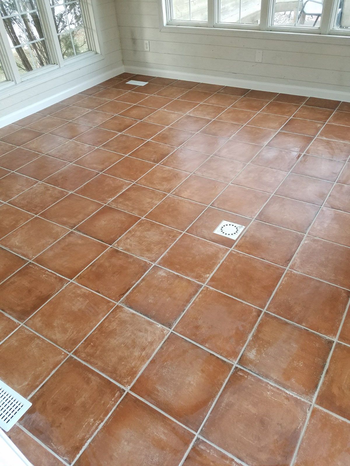 A room with a tiled floor and a window.