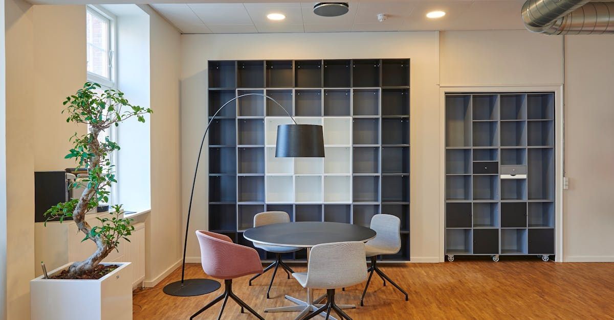 There is a table and chairs in the middle of the room.