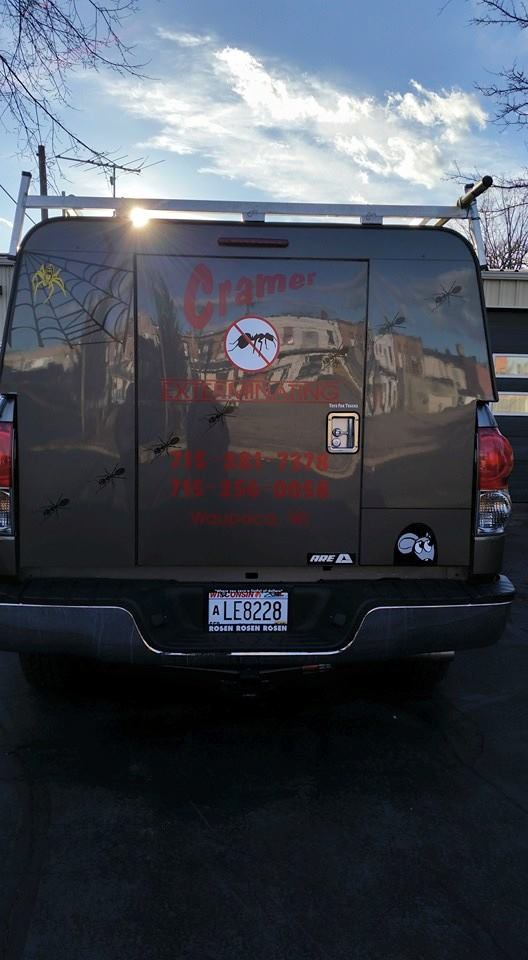 Pest control truck with logos on the back