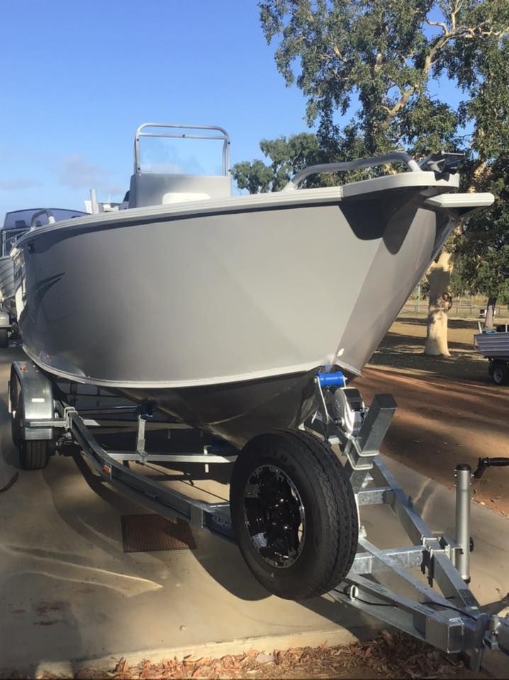Gray Boat On A Trailer, Parked Outside On A Sunny Day — In Tune Marine in Mackay, QLD