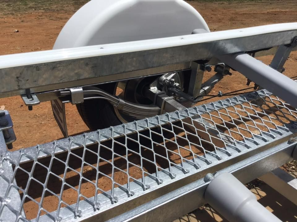Galvanized Metal Trailer With Diamond Mesh Bed, Near A Tire And Water Tank — In Tune Marine in Mackay, QLD