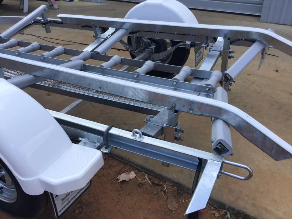 Boat Trailer With Silver Frame, Rollers, White Fenders, And Tire — In Tune Marine in Mackay, QLD