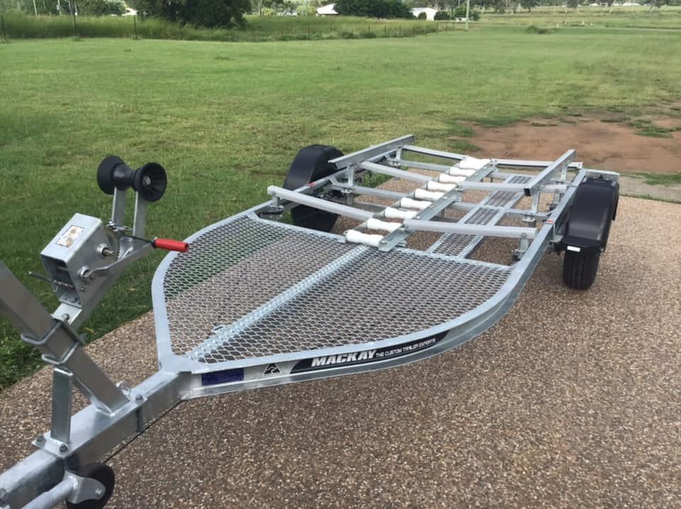 Boat Trailer on a Paved Surface, With Rollers, Winch, and Mesh Bed — In Tune Marine in Mount Isa, QLD