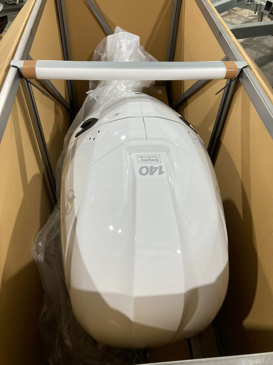 White, Oval-shaped Object Inside A Cardboard Shipping Container, Secured By A Plastic Wrap. The Object Has A Label That Reads "140" — In Tune Marine in Airlie Beach, QLD