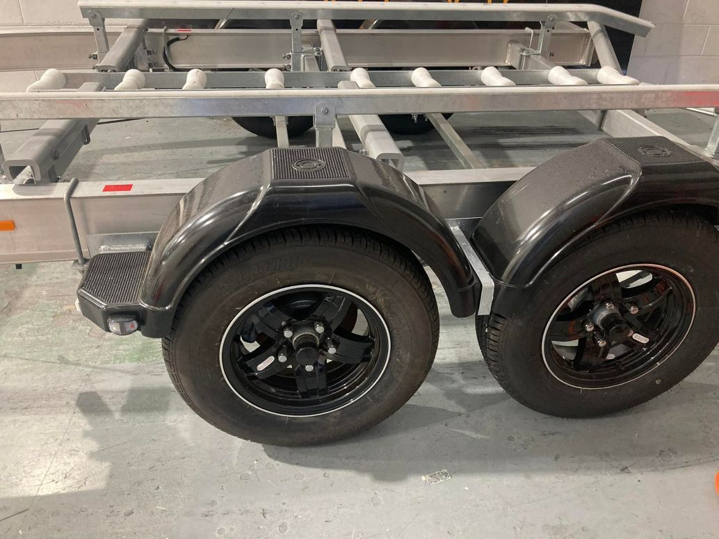 Black Tires With Black Rims On A Trailer With Black Fenders — In Tune Marine in Mackay, QLD
