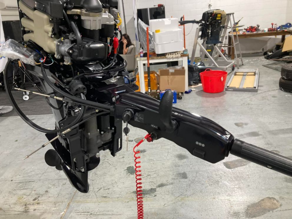 Black Outboard Motor With Tiller Arm, Red Kill Switch Cord, In A Shop — In Tune Marine in Airlie Beach, QLD