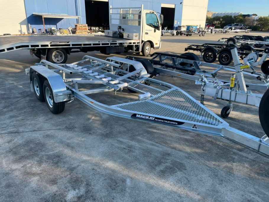 Boat Trailer on a Paved Lot Near a Truck — In Tune Marine in Airlie Beach, QLD