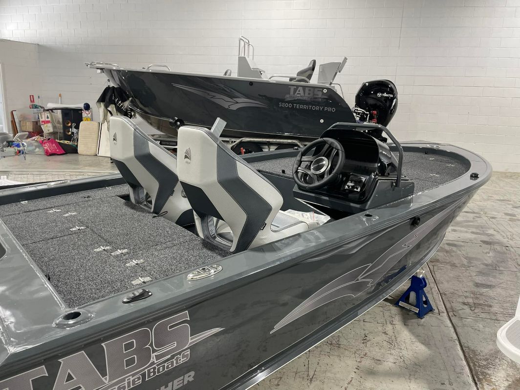 Gray Fishing Boat With Black Motor And Steering Wheel; Inside A Garage — In Tune Marine in Mackay, QLD