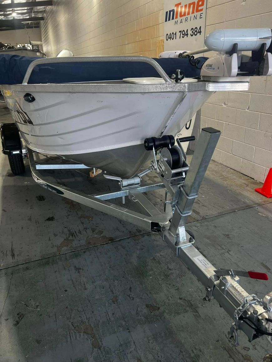 Aluminium Boat On A Trailer, Indoors. Boat Is Silver. The Trailer Is Silver — In Tune Marine in Mackay, QLD