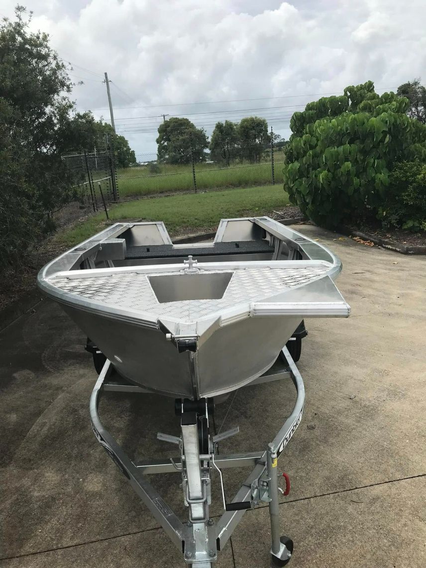 an Aluminum Boat on a Trailer — In Tune Marine in Mackay, QLD