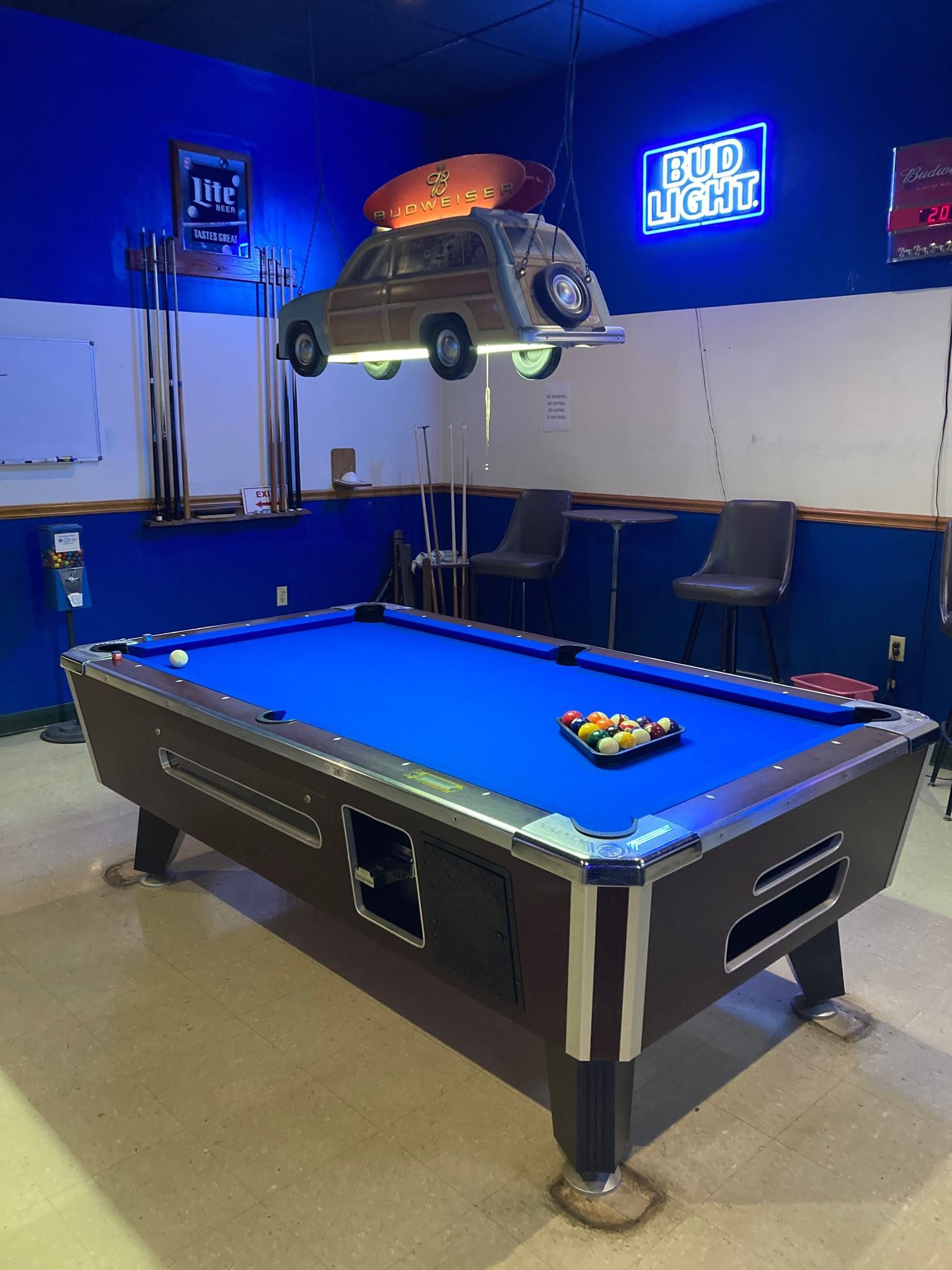 Claw machine filled with colorful plush toys; a silver claw descends over the toys.