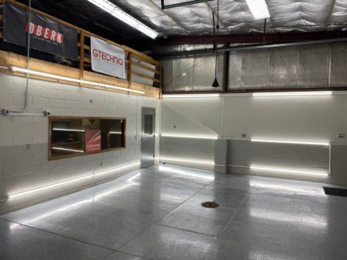 A large empty room with a lot of lights on the walls and floor.