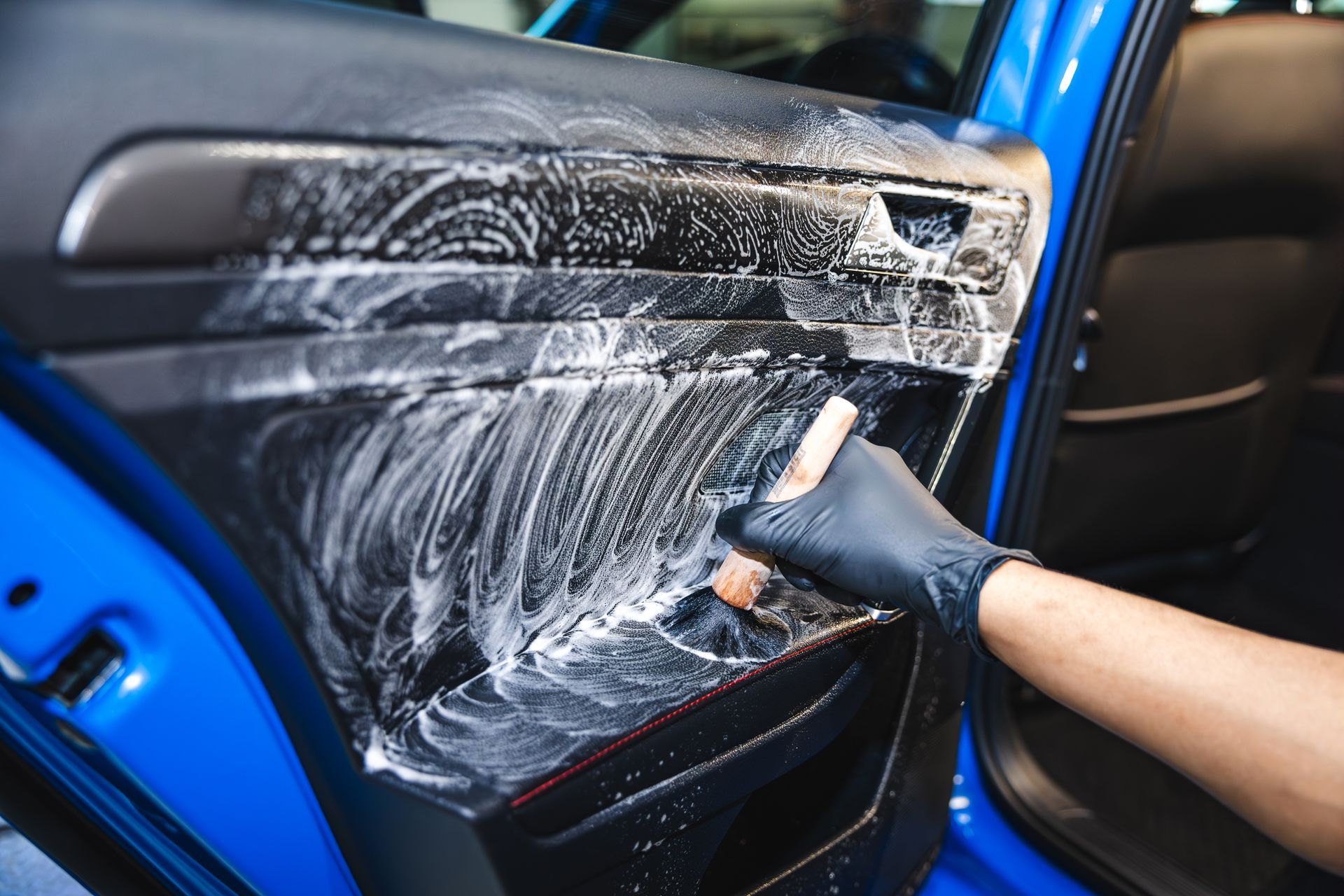 The rear seats of a range rover sport are red and black