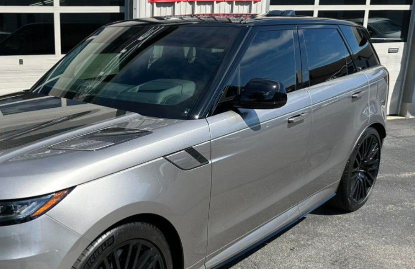Gray Range Rover with black accents, parked outdoors.