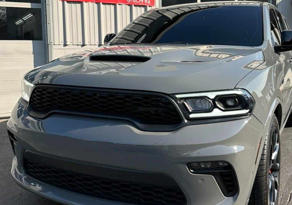 Gray Dodge Durango SUV with black grille and hood scoop.