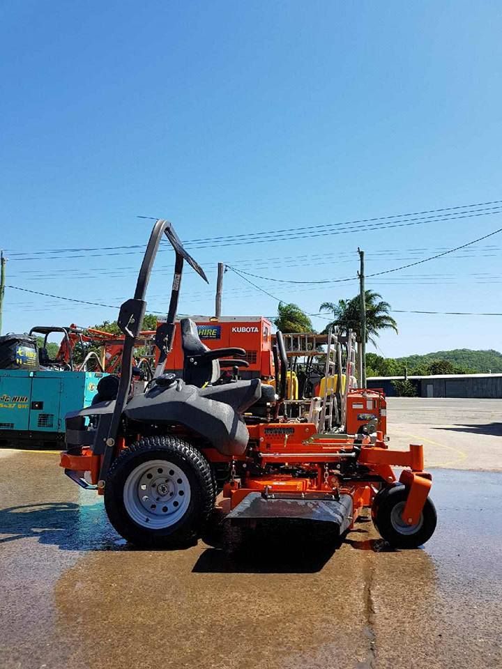 Orange-and-black Lawn Mower on Wet Pavement — JC Hire In Bli Bli, QLD
