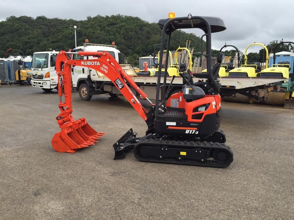 A Small Orange Excavator is Parked in a Parking Lot — JC Hire in Bli Bli, QLD