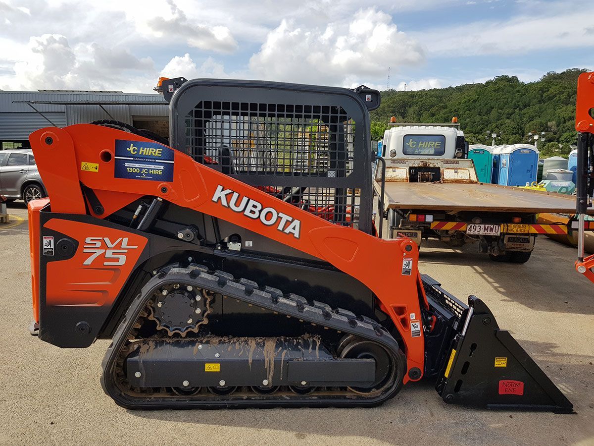 A Kubota Skid Steer Is Parked In A Parking Lot Next To A Truck — JC Hire In Nambour, QLD
