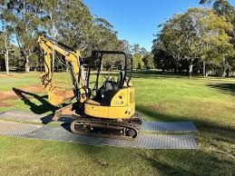 Black, rectangular rubber mat with a textured surface and holes.