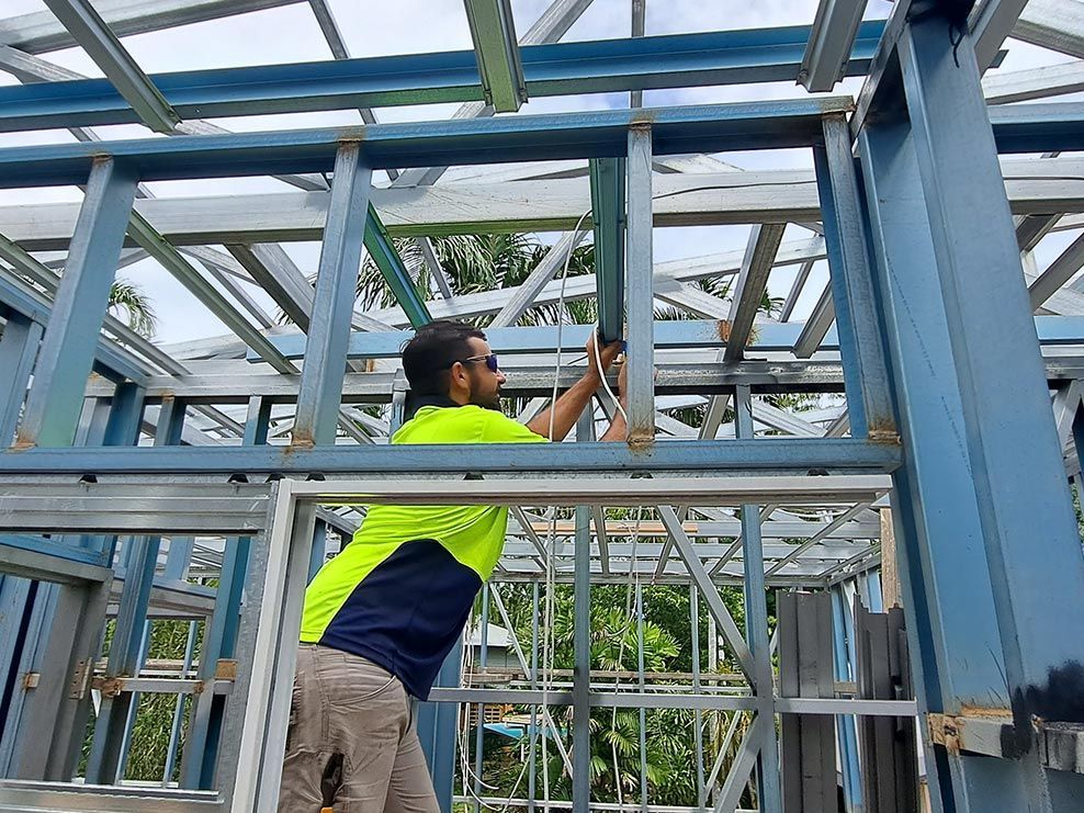 Man fixing the wires — Electricians in Palmerston, NT