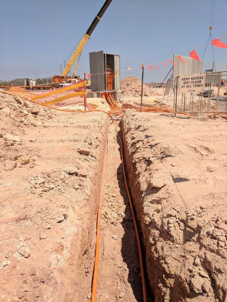 Orange Electrical Wires Laid Underground — Electricians in Palmerston, NT