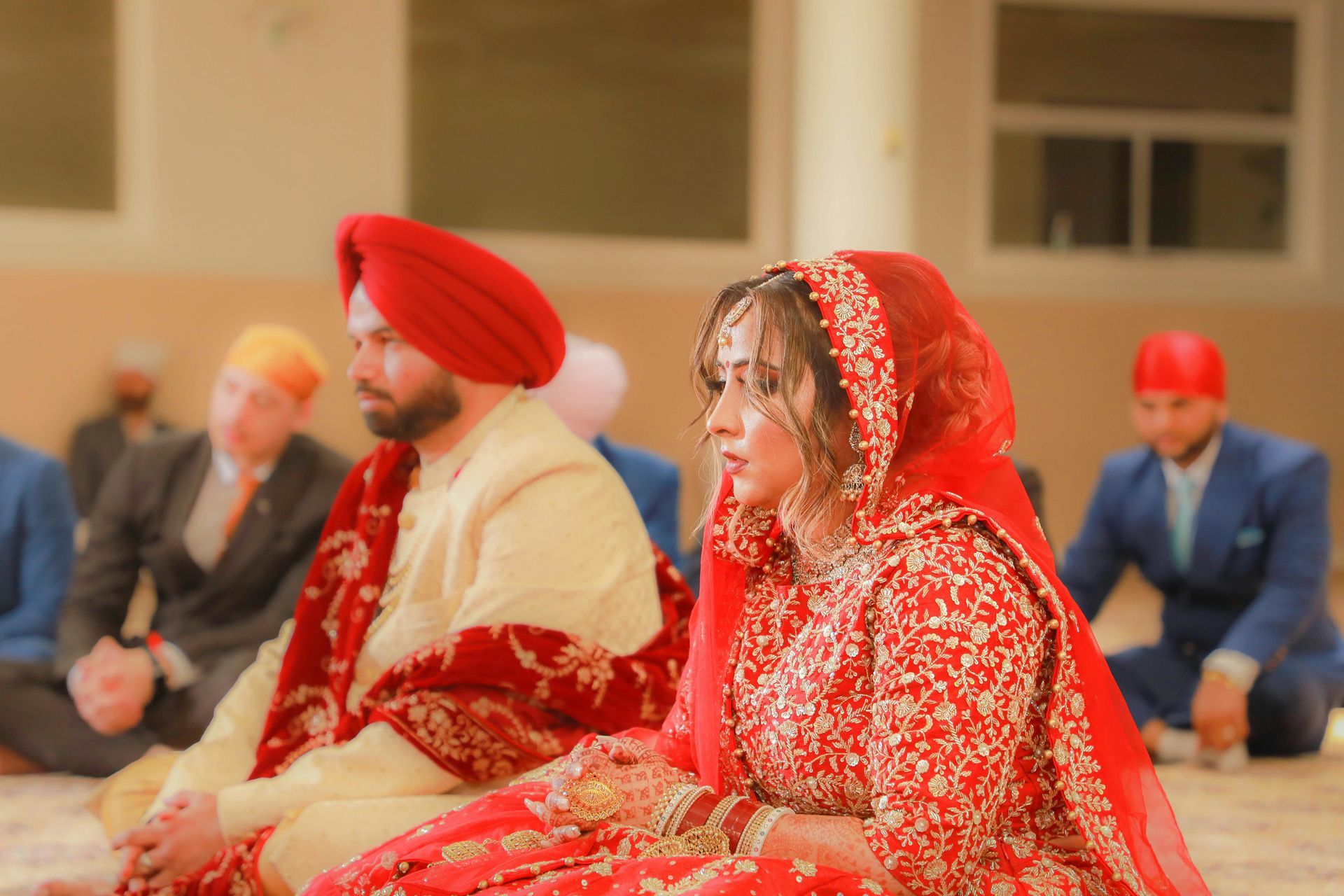 A bride and groom are sitting next to each other in a room.