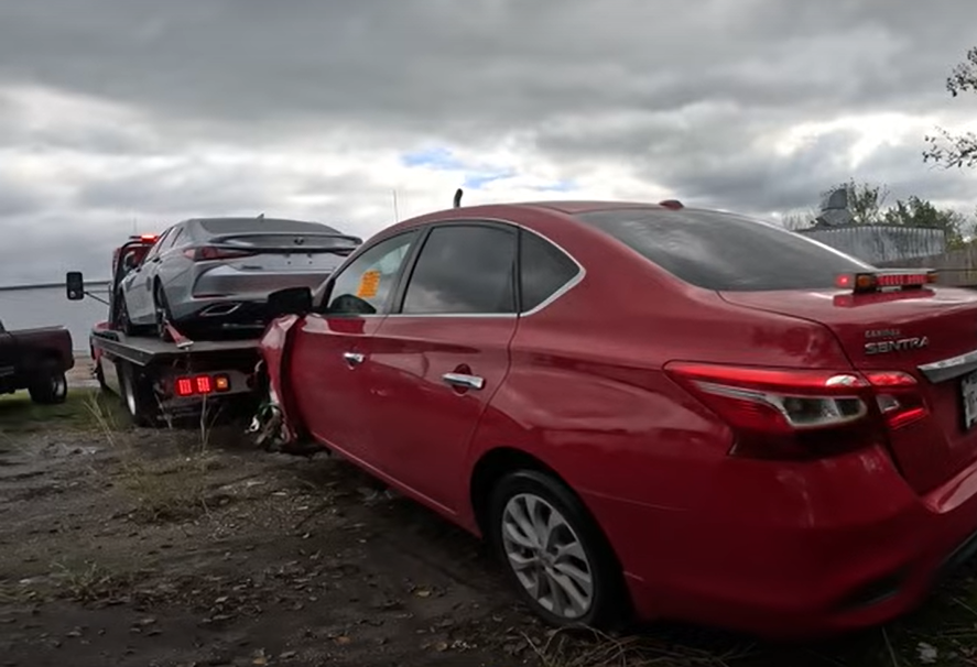 two vehicles being towed during emergency tow truck accident recovery on Aucklands North Shore