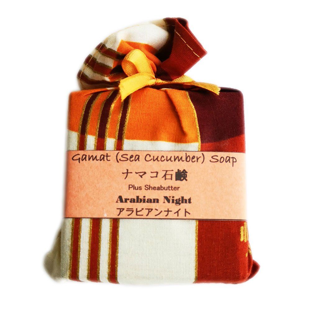 Wrapped soap in patterned fabric, tied with a yellow ribbon. Label reads 