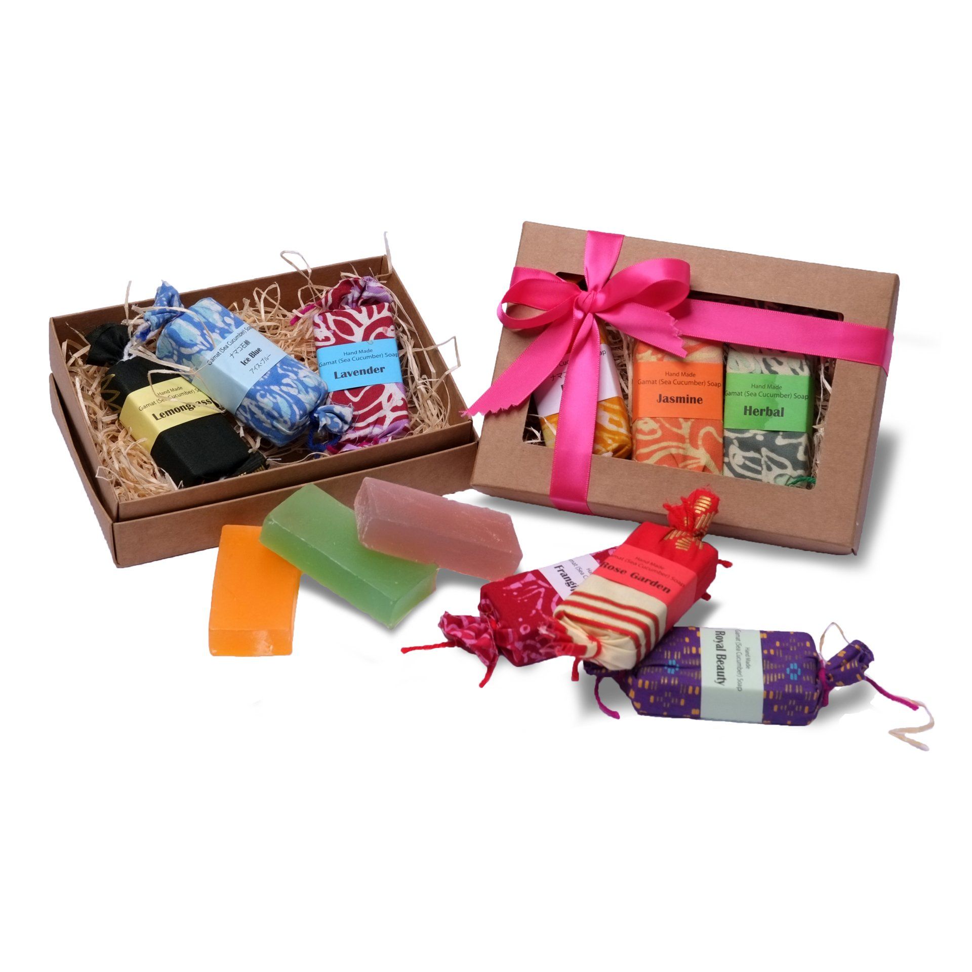 Two gift boxes of colorful soaps, some wrapped, some unwrapped, with a pink bow.