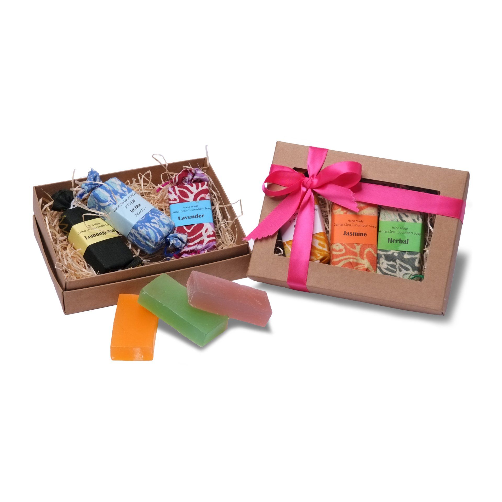 Gift boxes with soaps, various colors, tied with pink ribbon, on white background.