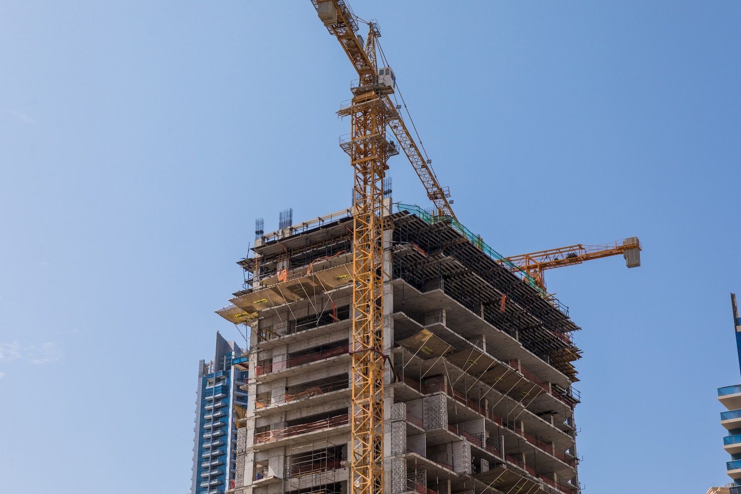 A tall building is being built with a crane.