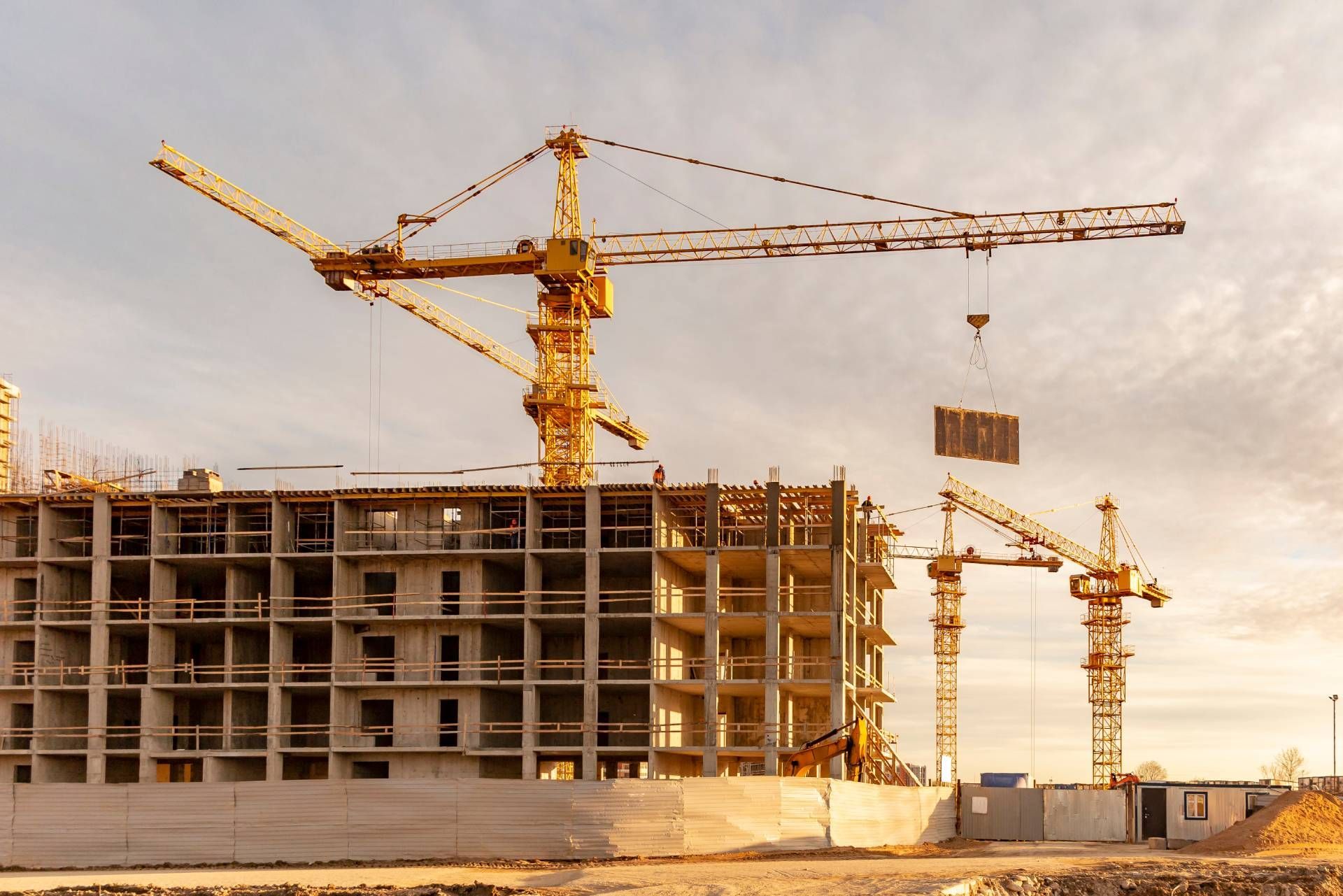 A large building is being built with a lot of cranes.