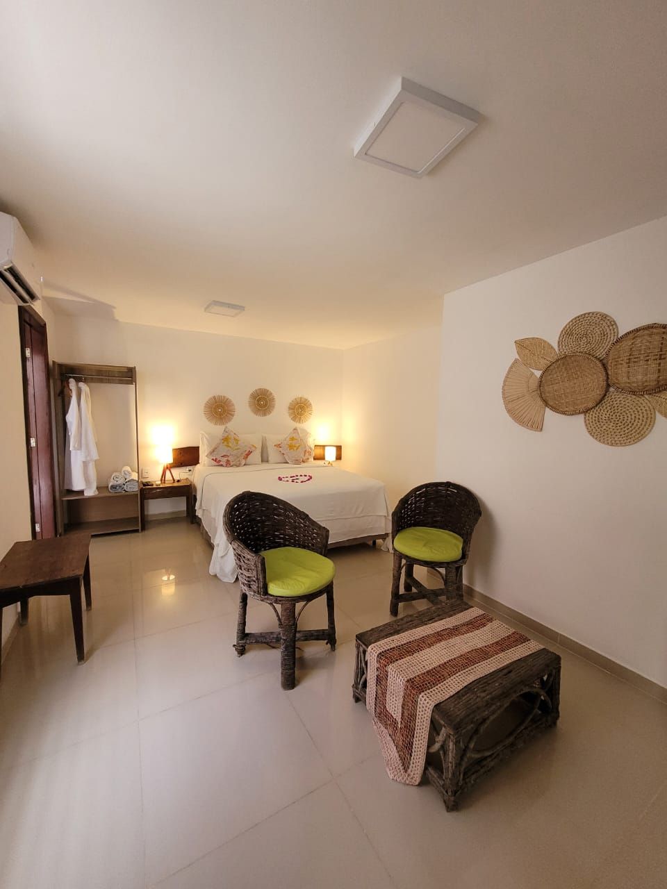 Um quarto com uma cama, cadeiras e uma mesa