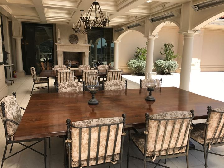 A dining room with a large table and chairs