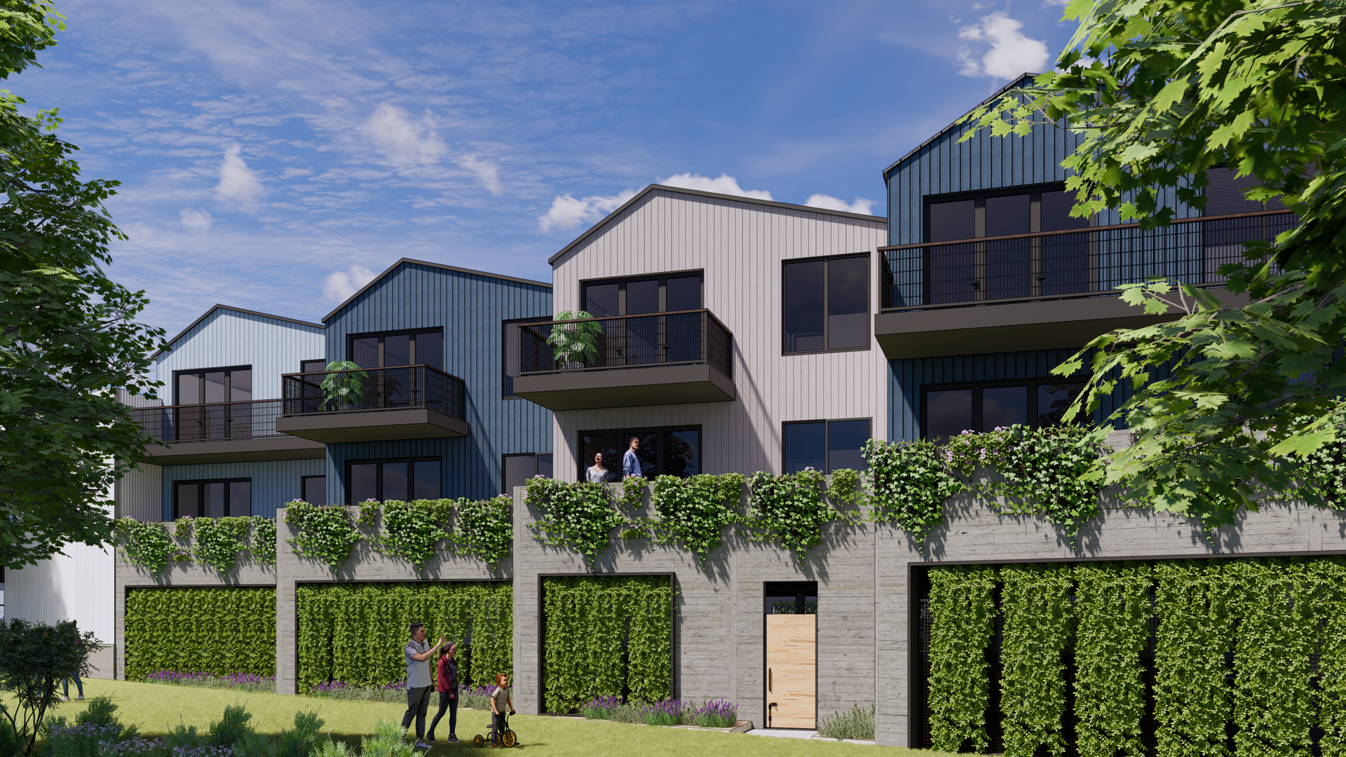 Row of modern homes with balconies, blue and white siding, behind a green wall. People walk below.