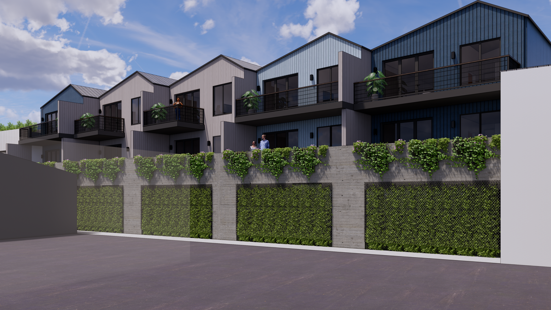 Row of modern townhouses with dark metal roofs, balconies, and a green ivy-covered wall.