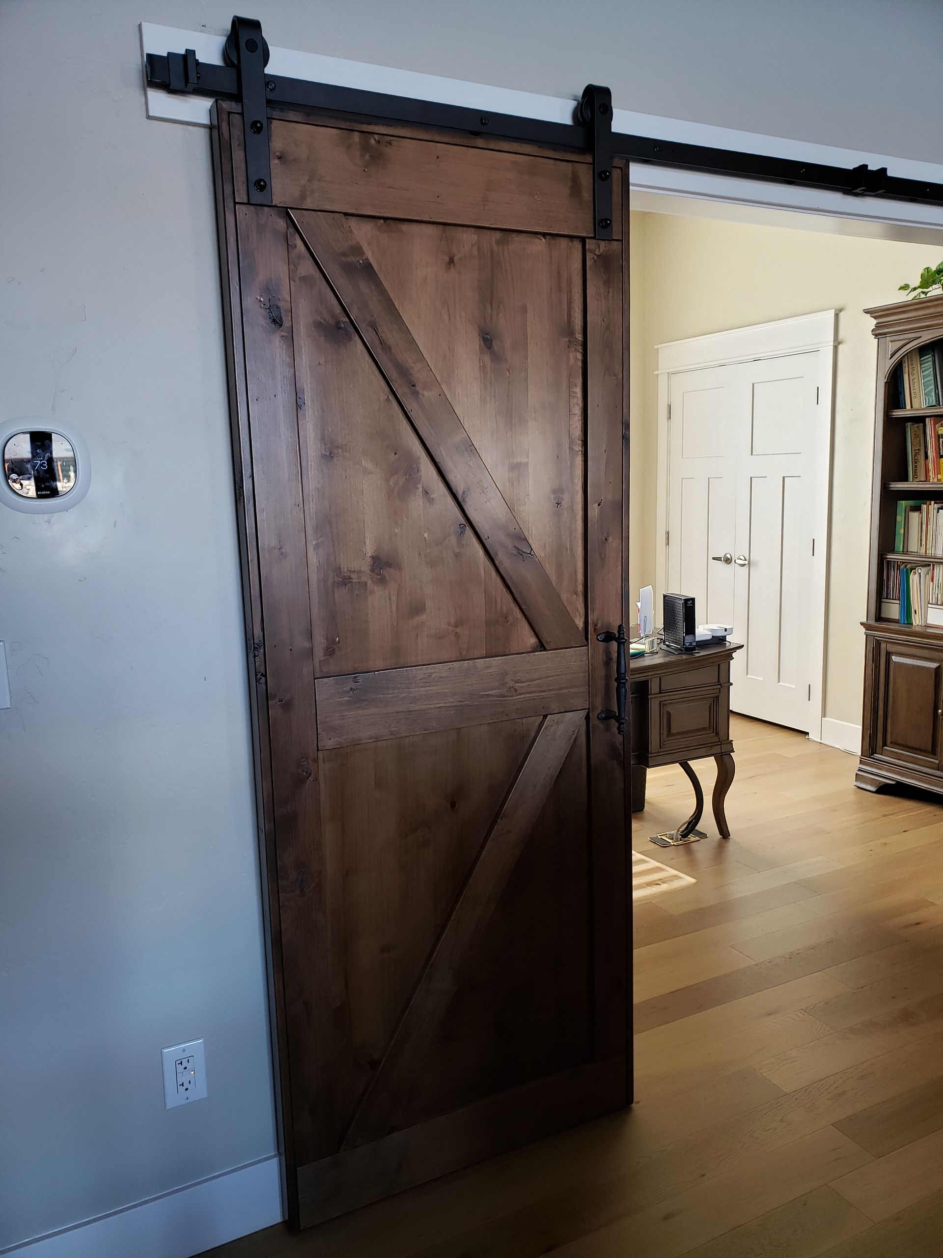 Wooden door with silver handle and lock mechanism.
