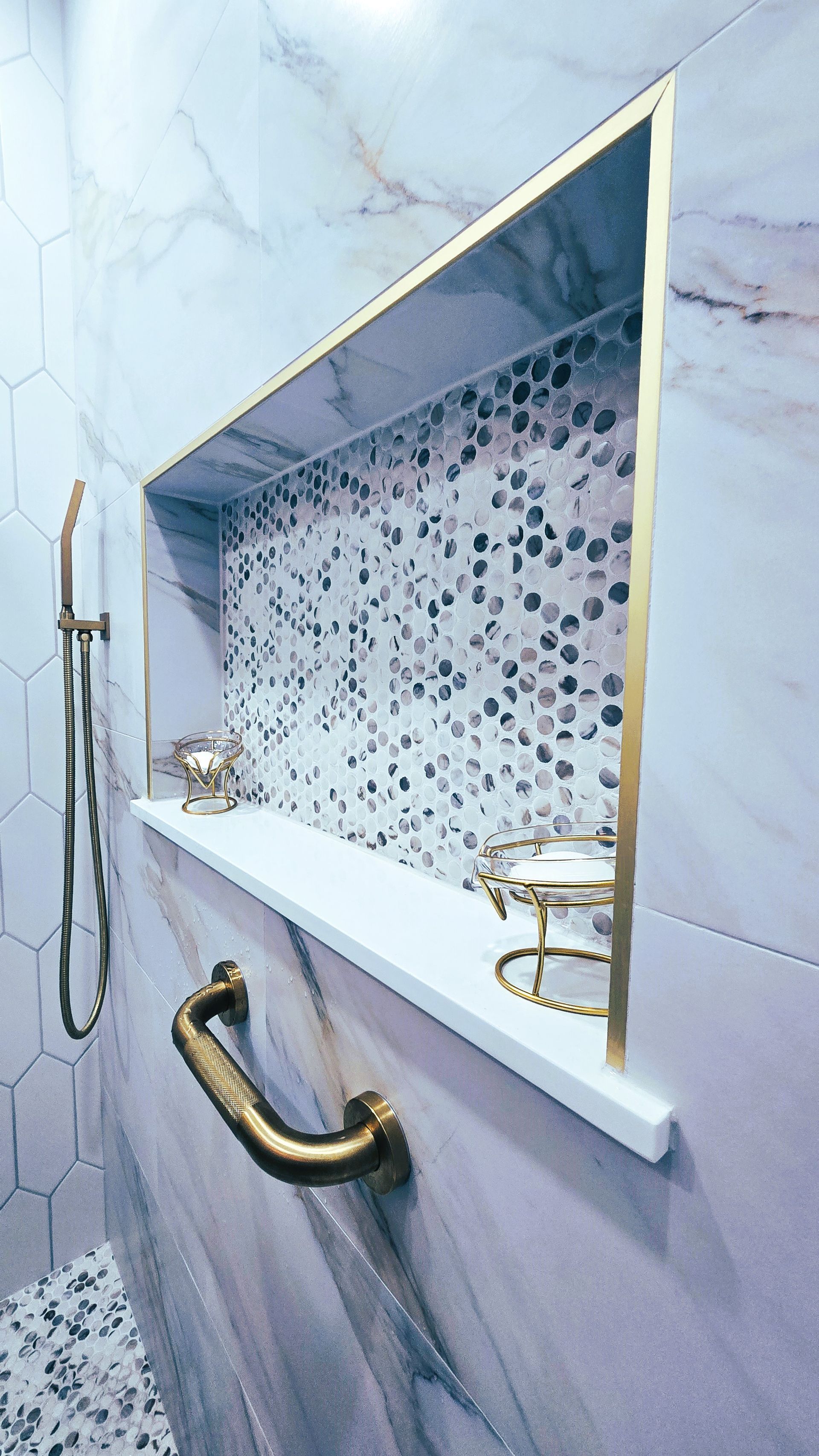 A bathroom with a shelf and a shower head.