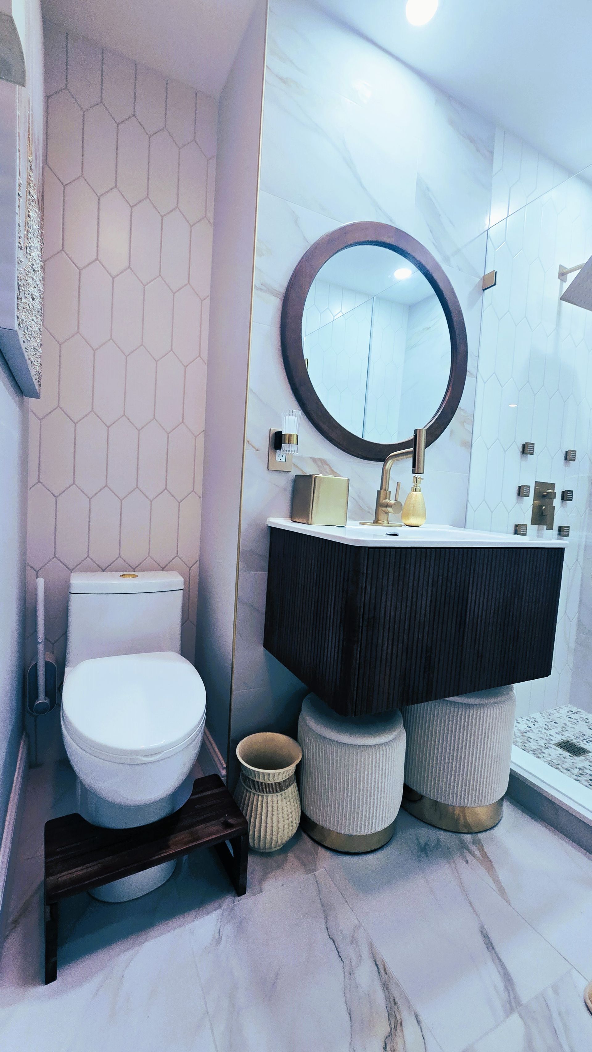 A bathroom with a toilet , sink and mirror.