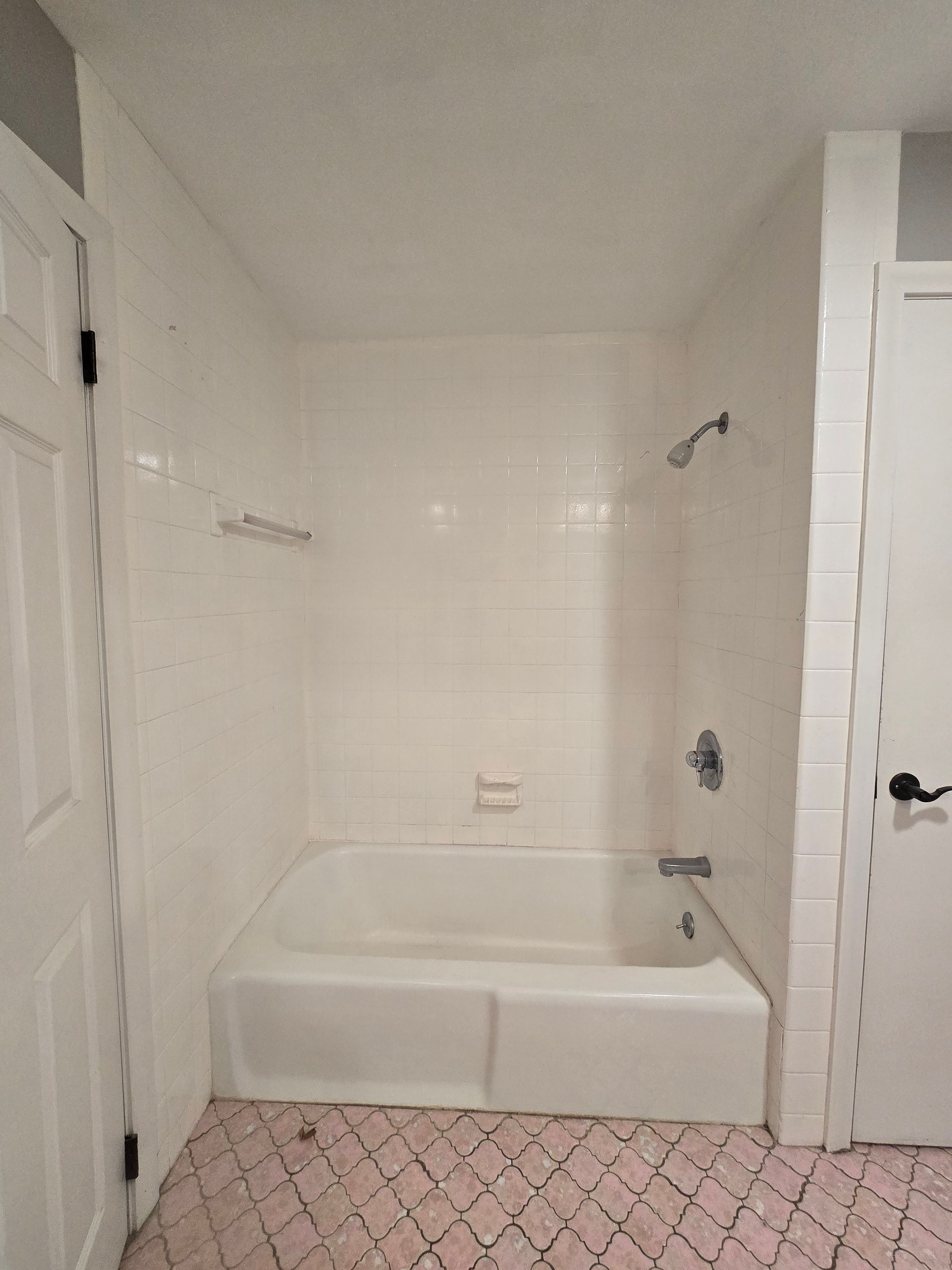 A bathroom with a walk in shower and a sink